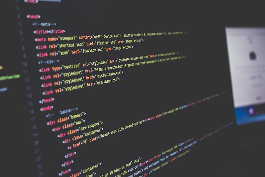 Website code on a monitor, showing the markup that search and AI crawlers read