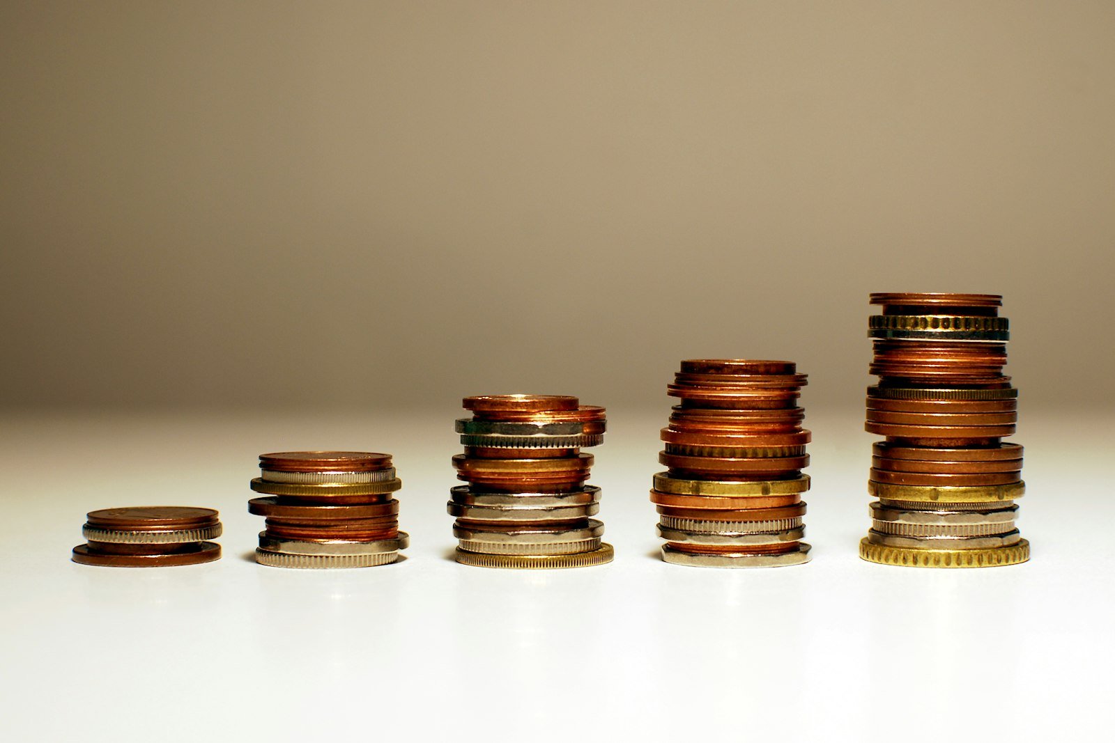 Stacks of coins getting taller from left to right
