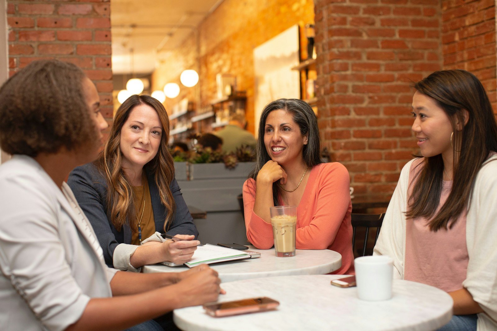 Three women talking over coffee, the kind of conversation that reveals what customers want