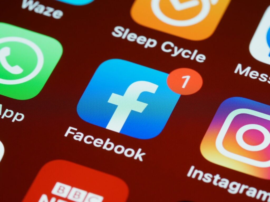 Facebook and Instagram app icons on a phone screen with a notification badge