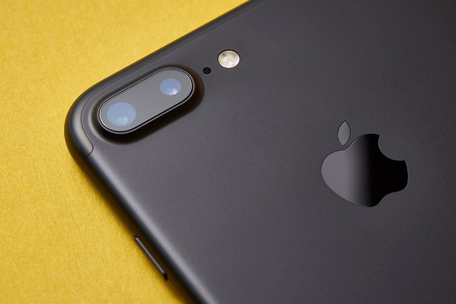 A smartphone on a yellow surface, representing mobile-first landing page design