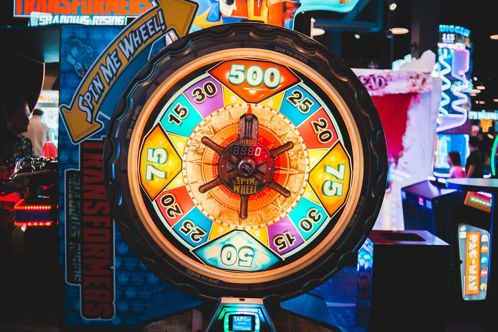 A colourful spin-to-win prize wheel lit up at a fair