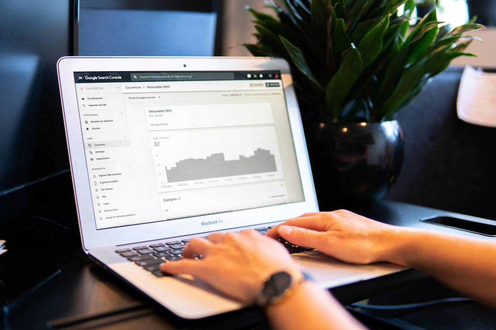 Person looking at a search performance report with a traffic graph on a laptop