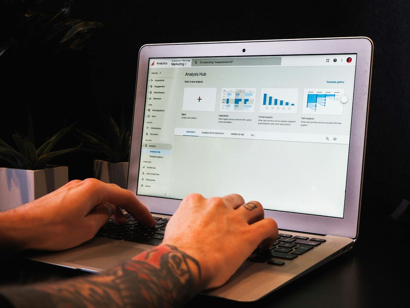 Person typing on a laptop with a web app dashboard open on screen