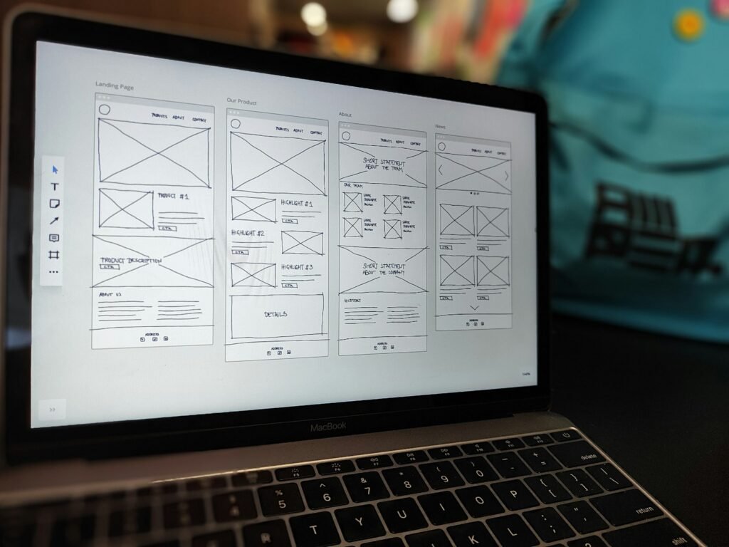 Website wireframes displayed on a laptop screen