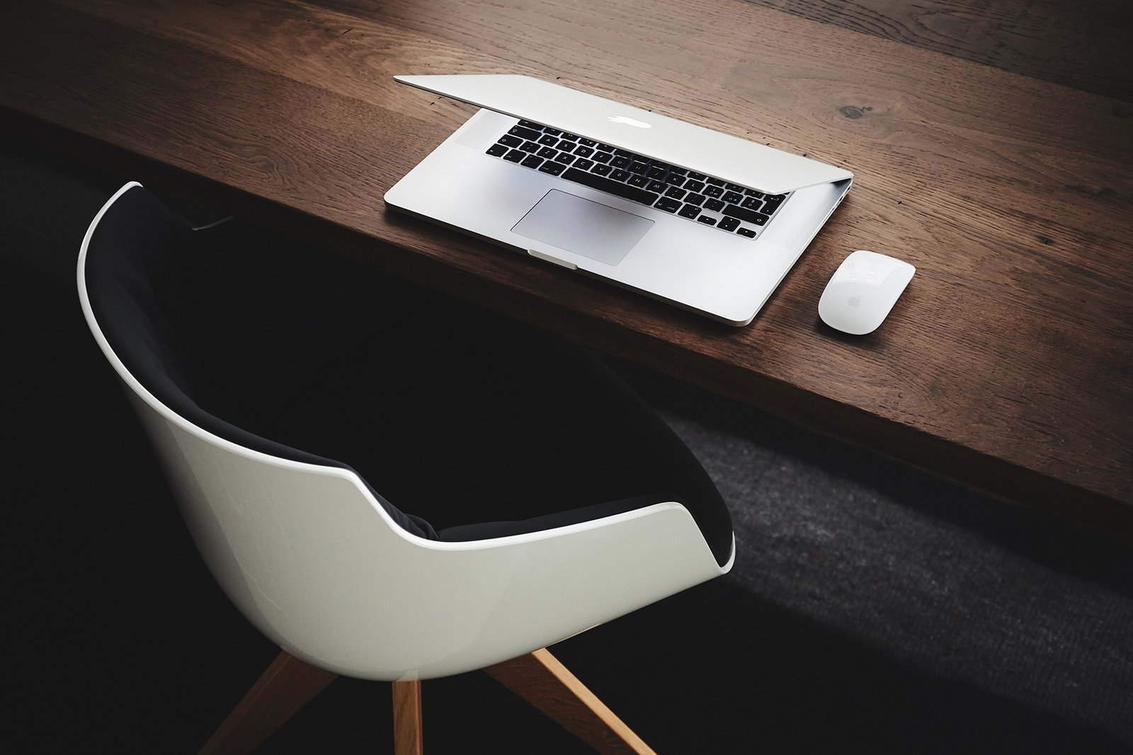 A laptop on a dark wooden desk